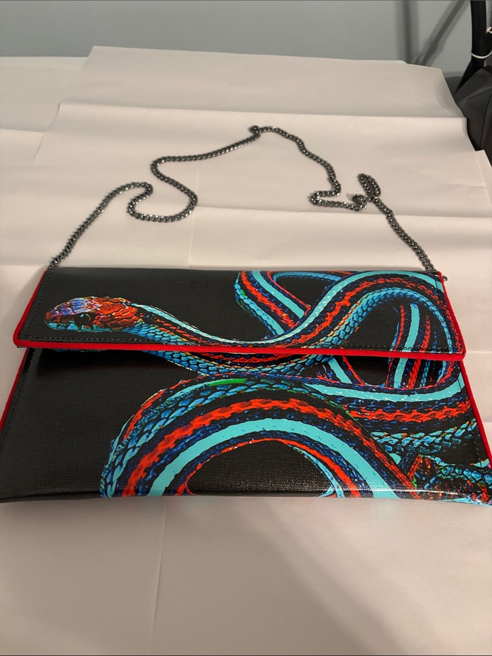 Black Clutch with Multicolor Snake Print and Red Trim